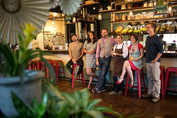 Group of people posing for a picture inside a restaurant