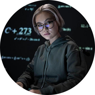 Female hacker looking towards camera.