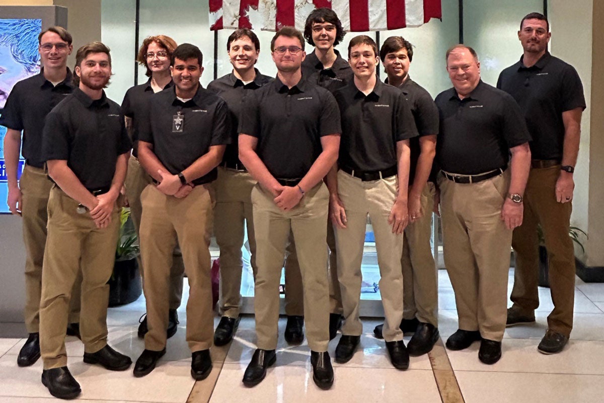 A group of UCF students and a faculty member posing for a photo