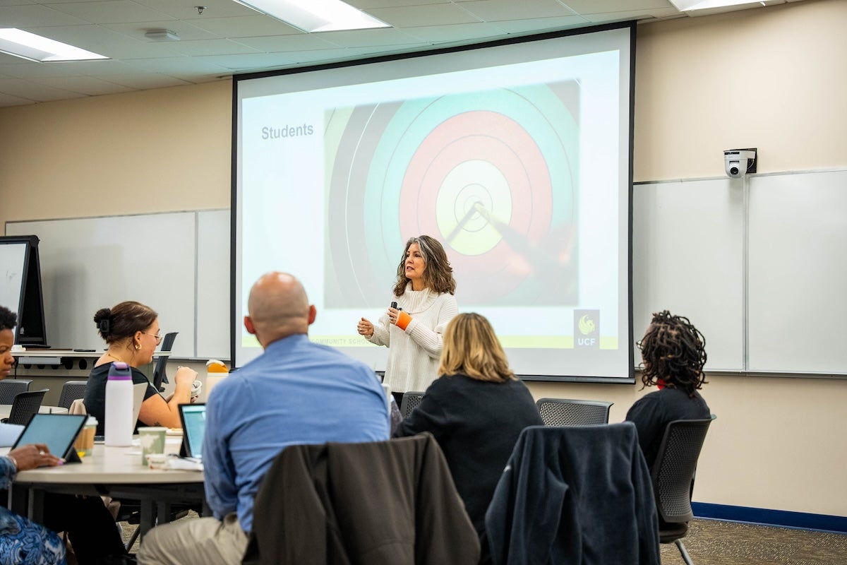 A woman speaking to a room of people