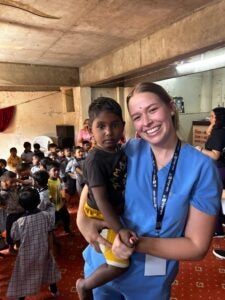 UCF biomedical sciences student holds young boy in her arms