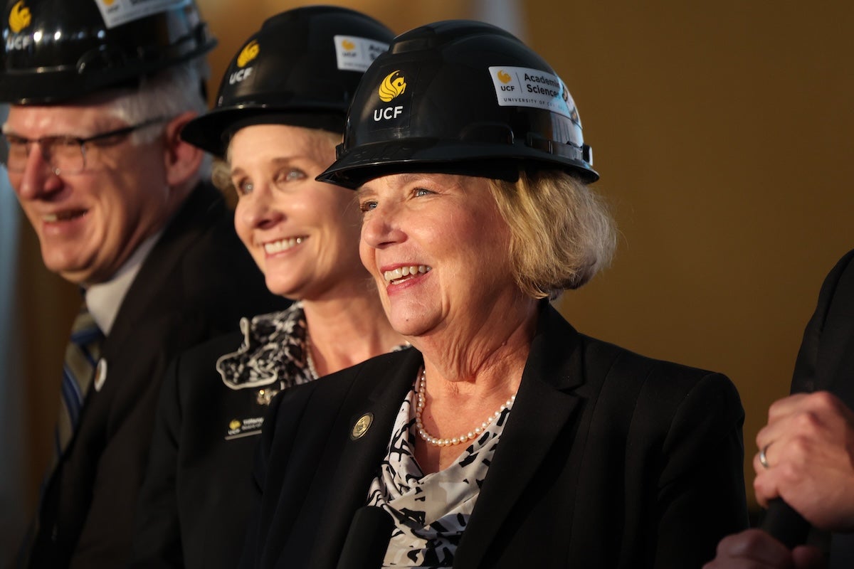 Mary Lou Sole wearing a hard hat with the UCF Pegasus logo