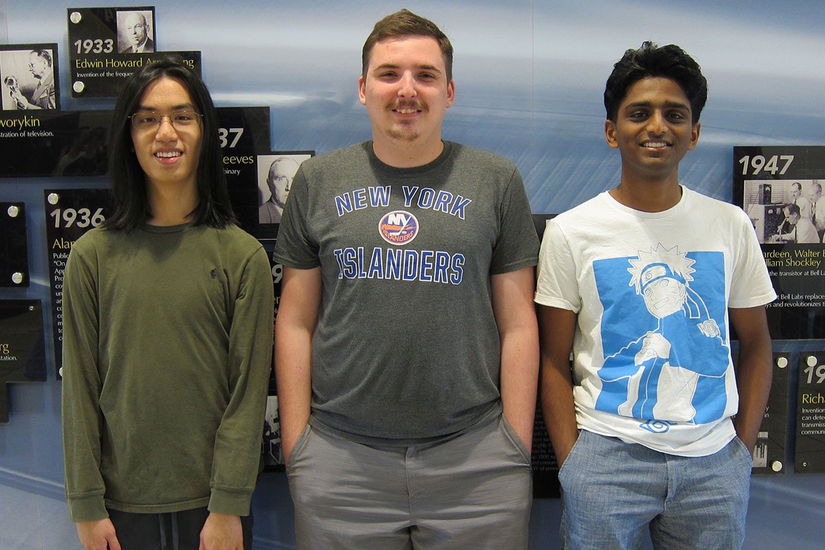 Three members of UCF's winning programming team pose for a photo together