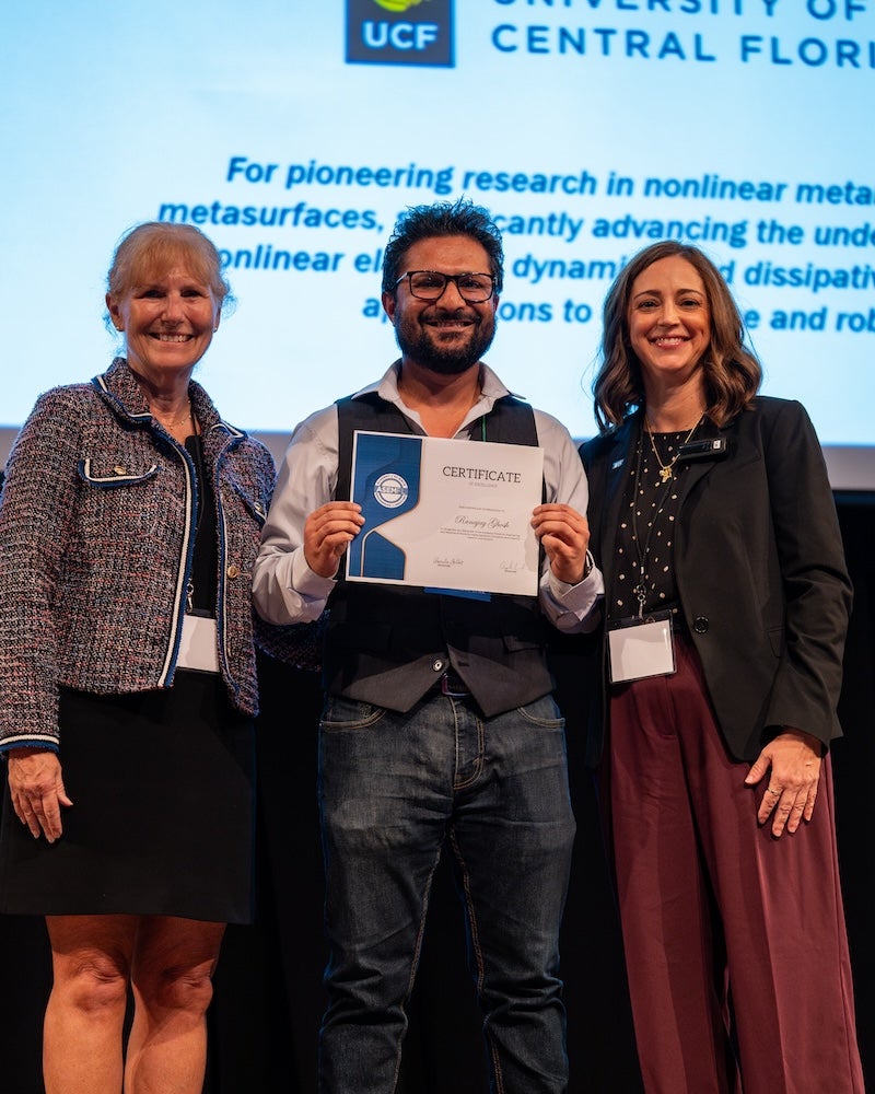 Ranajay Ghosh receiving an award on stage.