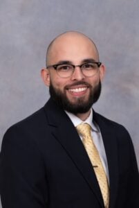 Portrait photo of a UCF alumnus wearing a suit and tie