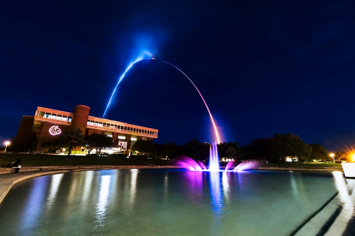 A rocket launches above the Reflecting Pond at UCF.