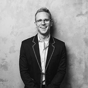 Headshot photo of a man wearing a suit