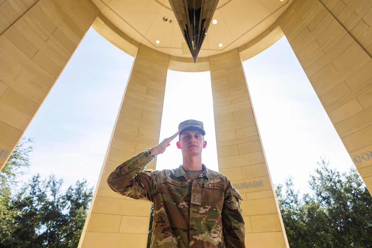 A UCF Air Force ROTC student in uniform salutes