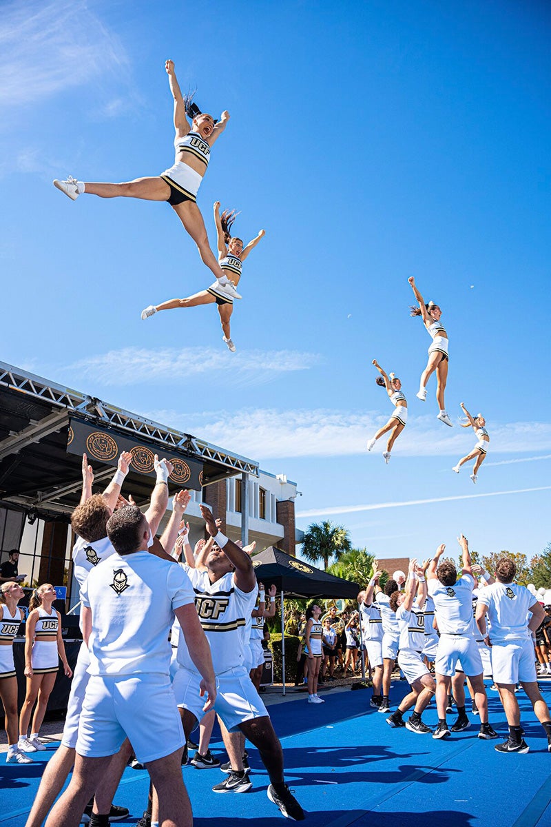 UCF cheerleaders perform stunt routine during Spirit Splash at UCF's main campus