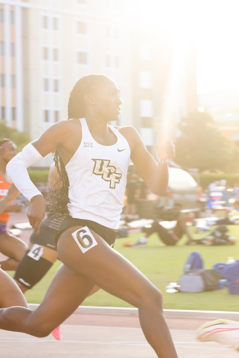 A member of the UCF women's track and field team runs on a track