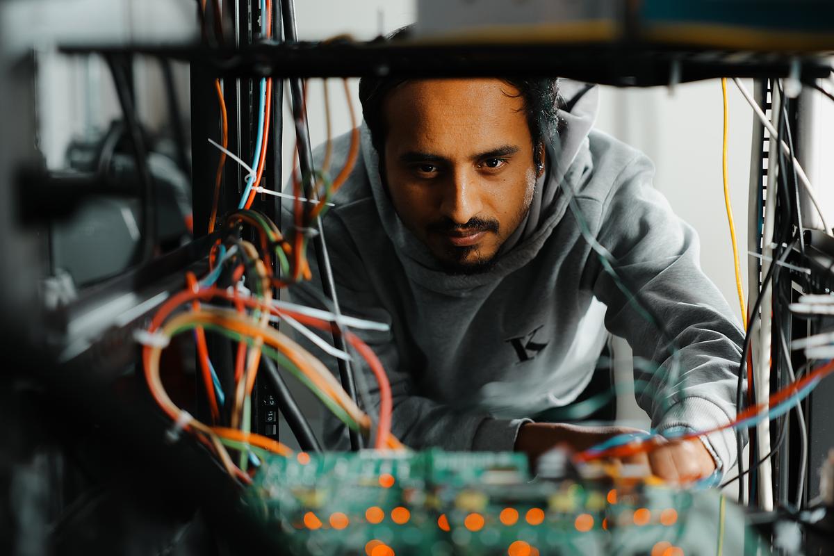 Student configures wires in a lab