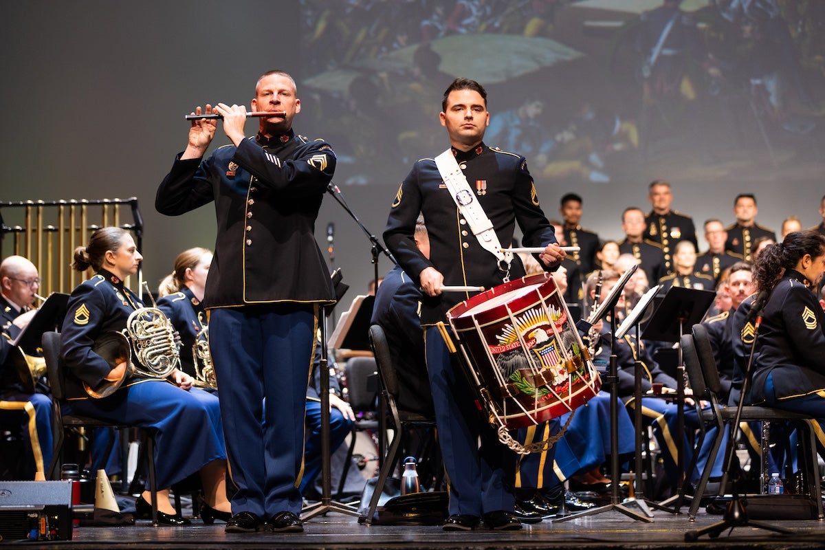 Members of the United States Army Field Band perform onstage