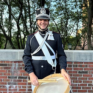 Theodore Jackson, a UCF percussion alum, poses for a photo with a drum