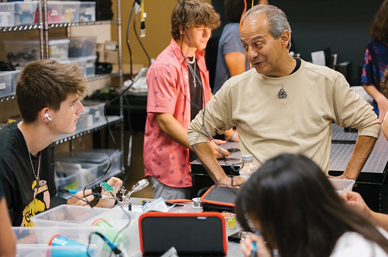 A faculty member speaking with a student