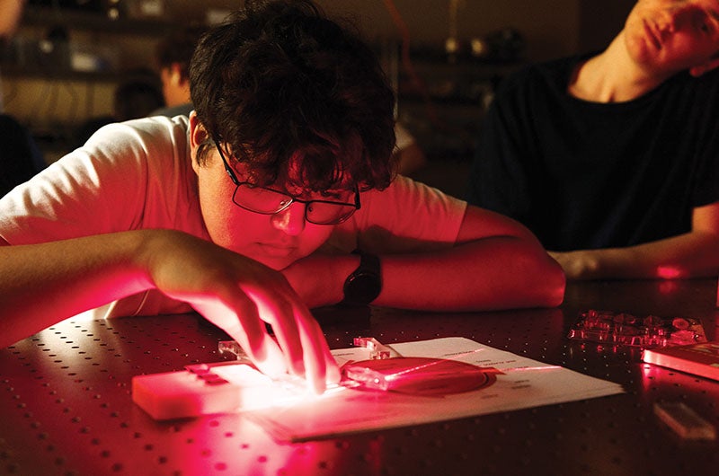 A student looking at a laser