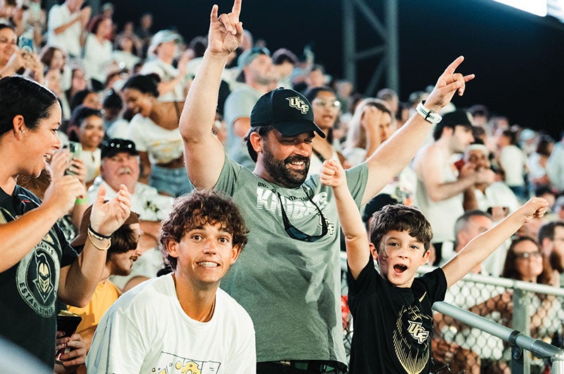 A crowd of fans cheering at a football game